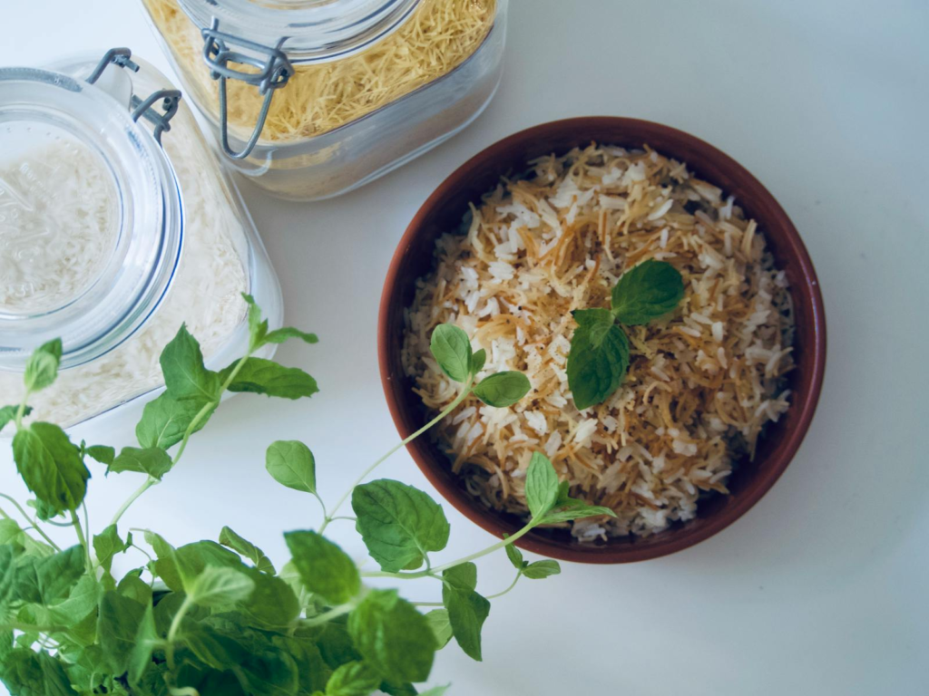 A succulent bowl of rice garnished with fresh mint leaves, perfect for a culinary delight.