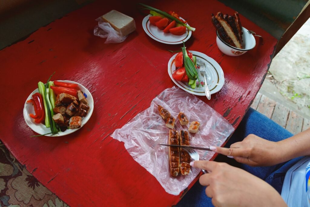 Someone is cutting food on a table.