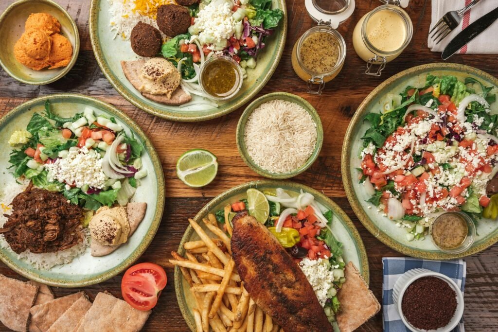 A wooden table topped with plates of food