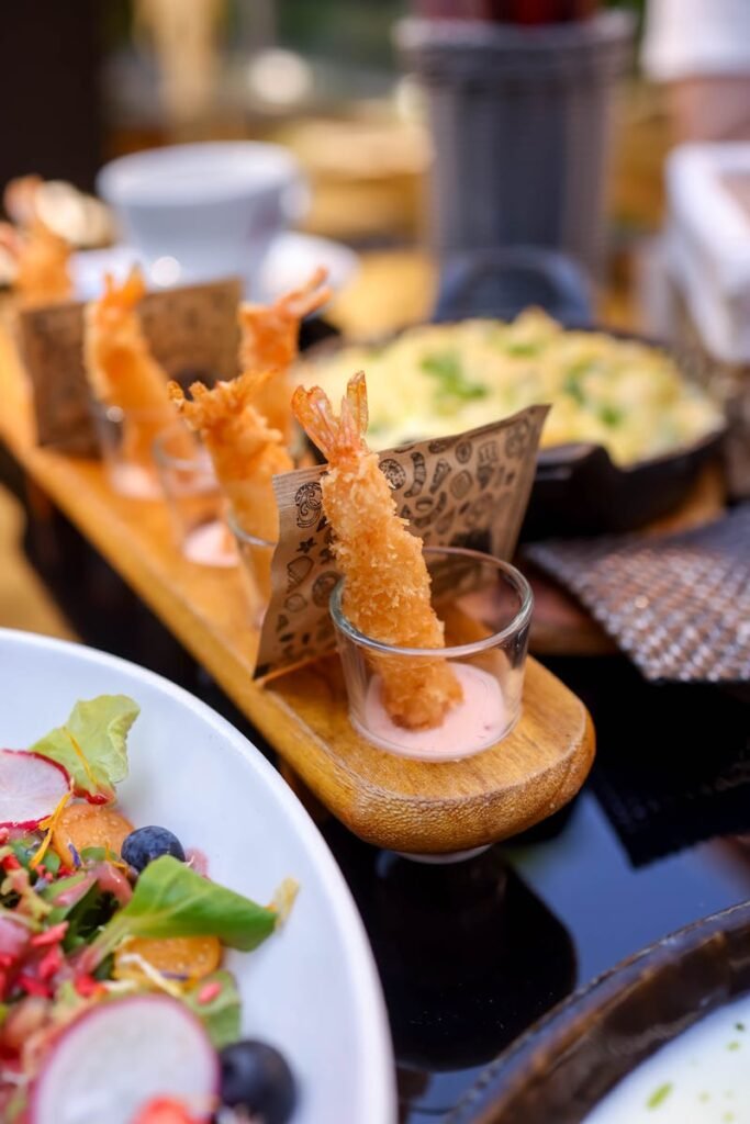 Delicious shrimp tempura appetizers paired with sauce, perfect for restaurant menus.