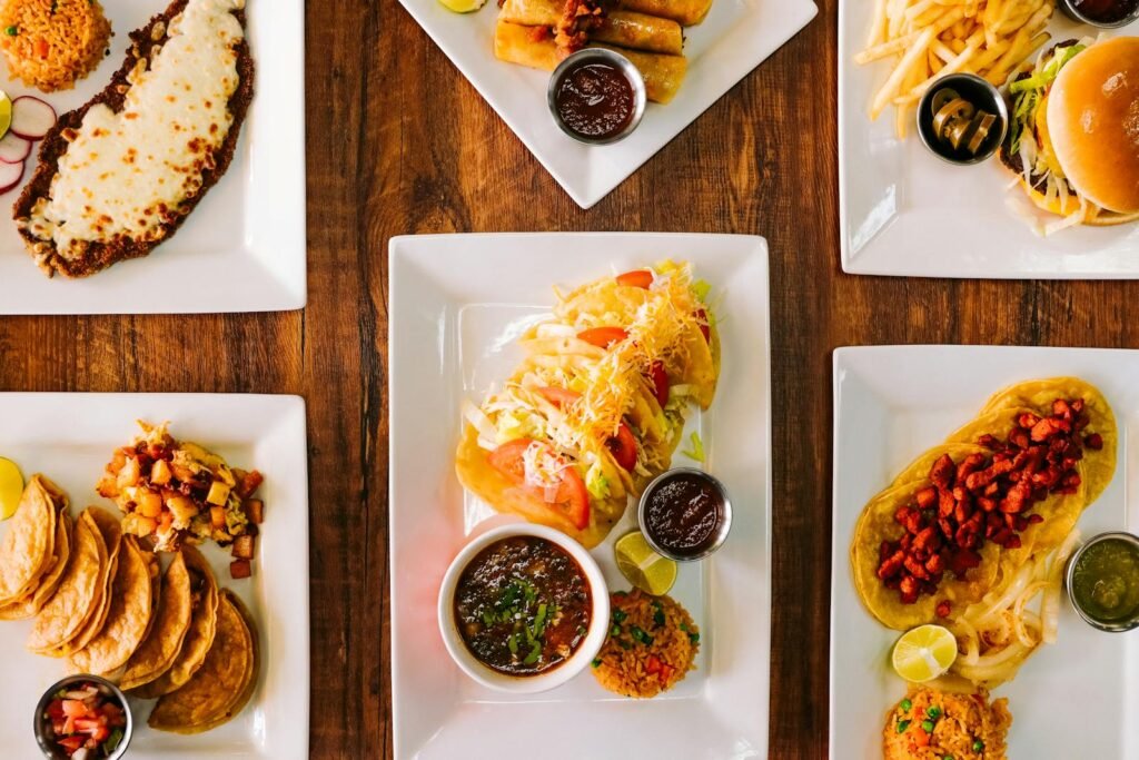 Colorful Mexican dishes including tacos, enchiladas, and fries beautifully plated for a flavorful lunch.