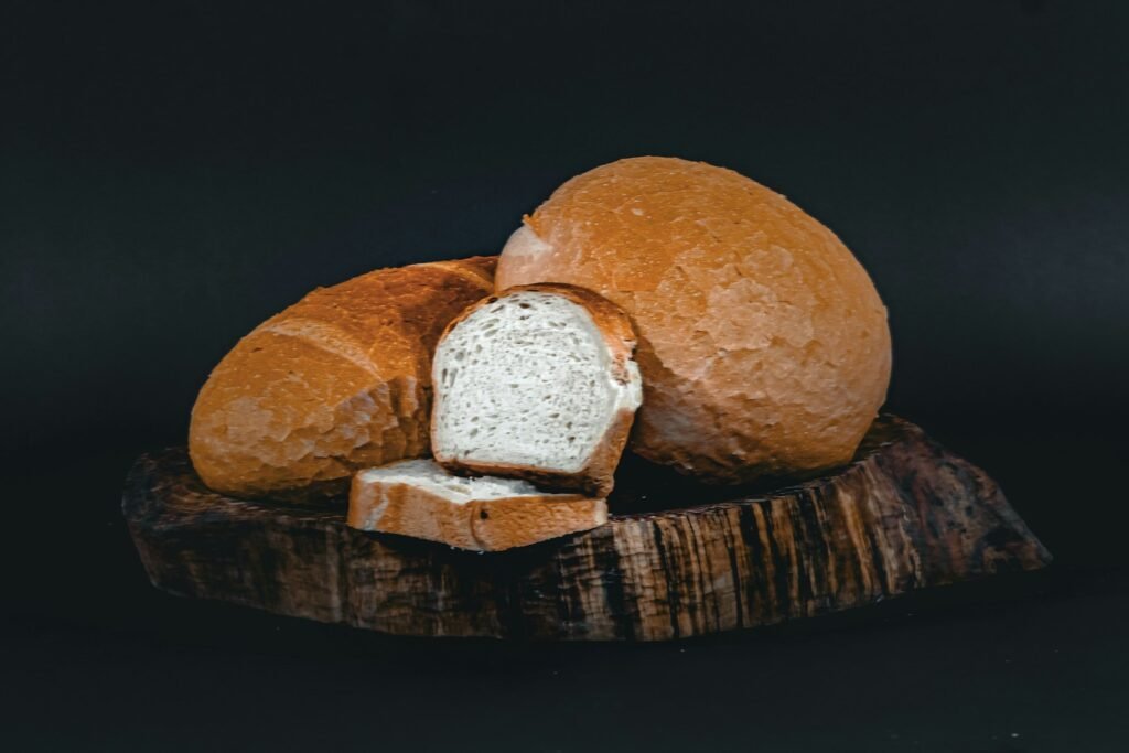 a loaf of bread sitting on top of a wooden cutting board